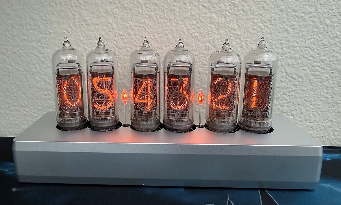 Close technical view of six glowing IN-14 Nixie tubes and two neon separator lamps